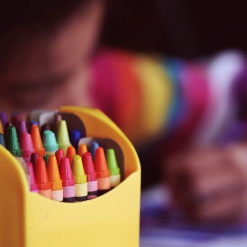 a box of colouring crayons with a blurred background