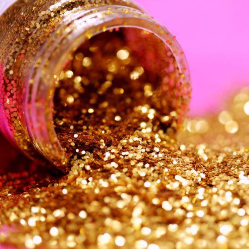 a jar of gold glitter spilling onto the floor