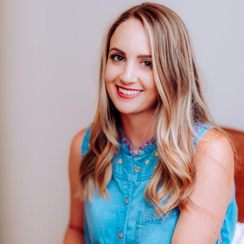 a profile picture of a woman looking at the camera and smiling