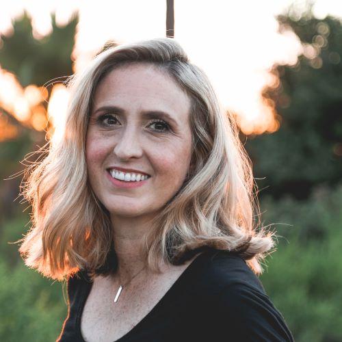 a profile picture of a blond woman looking at the camera and smiling