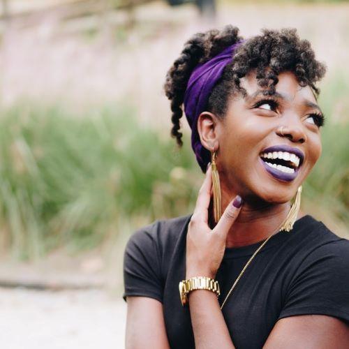 a profile picture of a woman looking to the side and smiling